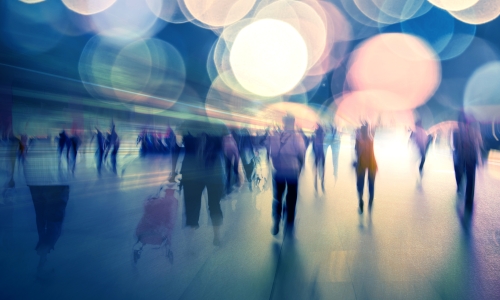 Fuzzy images of people walking in light
