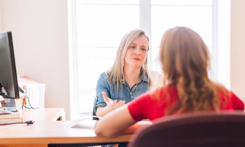 Two women talking at work