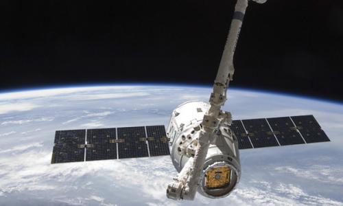 Space X Dragon satellite orbiting earth