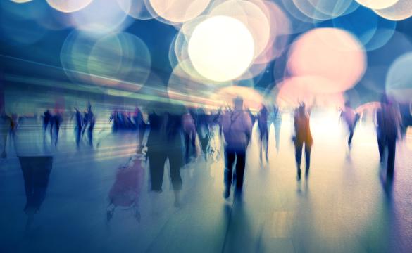 Fuzzy images of people walking in light