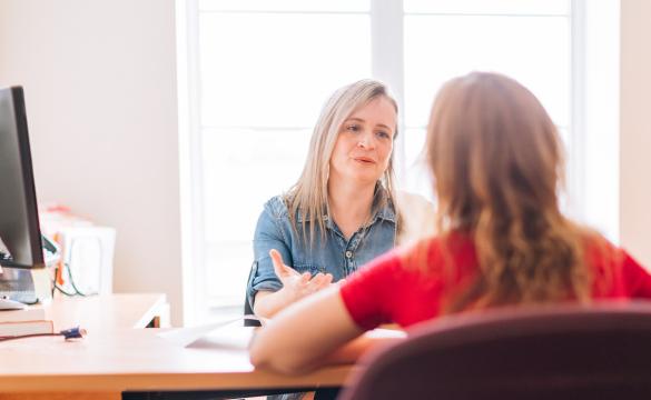 Two women talking at work