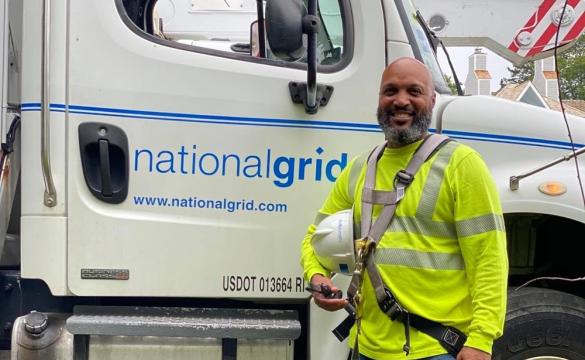 US Lineworker Donald Lopes in front of National Grid bucket truck