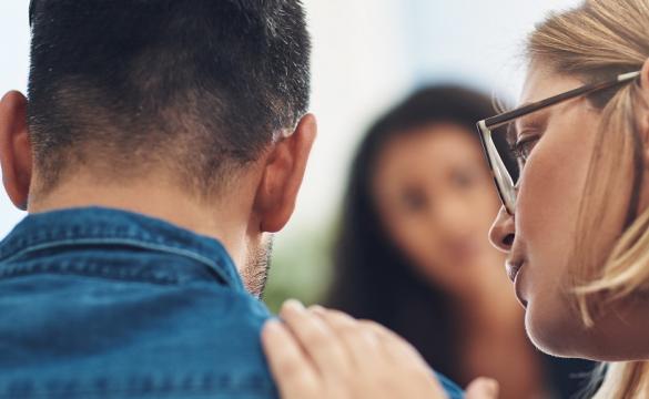 Woman talking to a man with her hand on his shoulder
