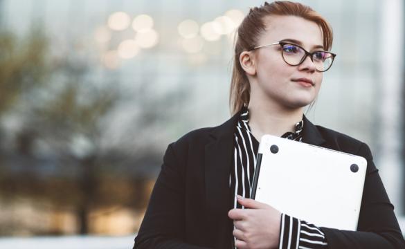 Young woman holding laptop used for National Grid US virtual internships story