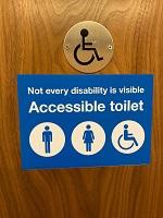 Disability toilet sign_150x200.jpg Disability toilet sign on wooden door for National Grid article on disability