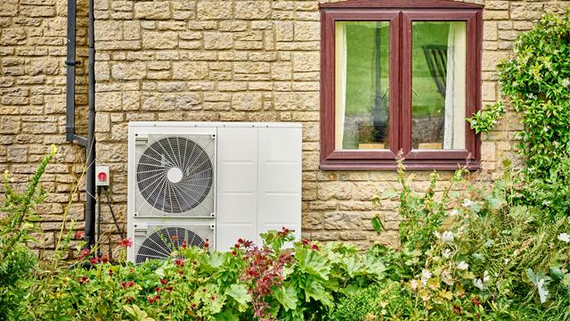 ElectricHeatPump_Getty1333639644_640x360.jpg Electric heat pump on a yellow brick building by a window