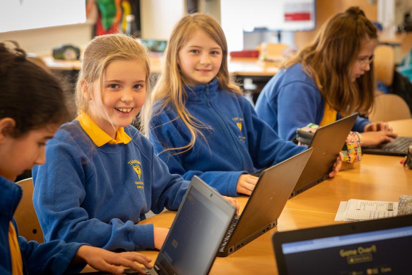 Young school students with new laptops