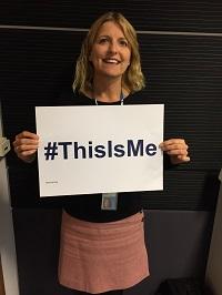 Sarah Stanton_This is me_200x266.jpg A middle aged woman holing up a poster with This is me hashtag for National Grid article on disability.
