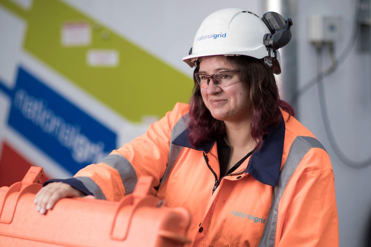 Swansea ET worker.jpg National Grid engineer wearing PPE opening an orange box